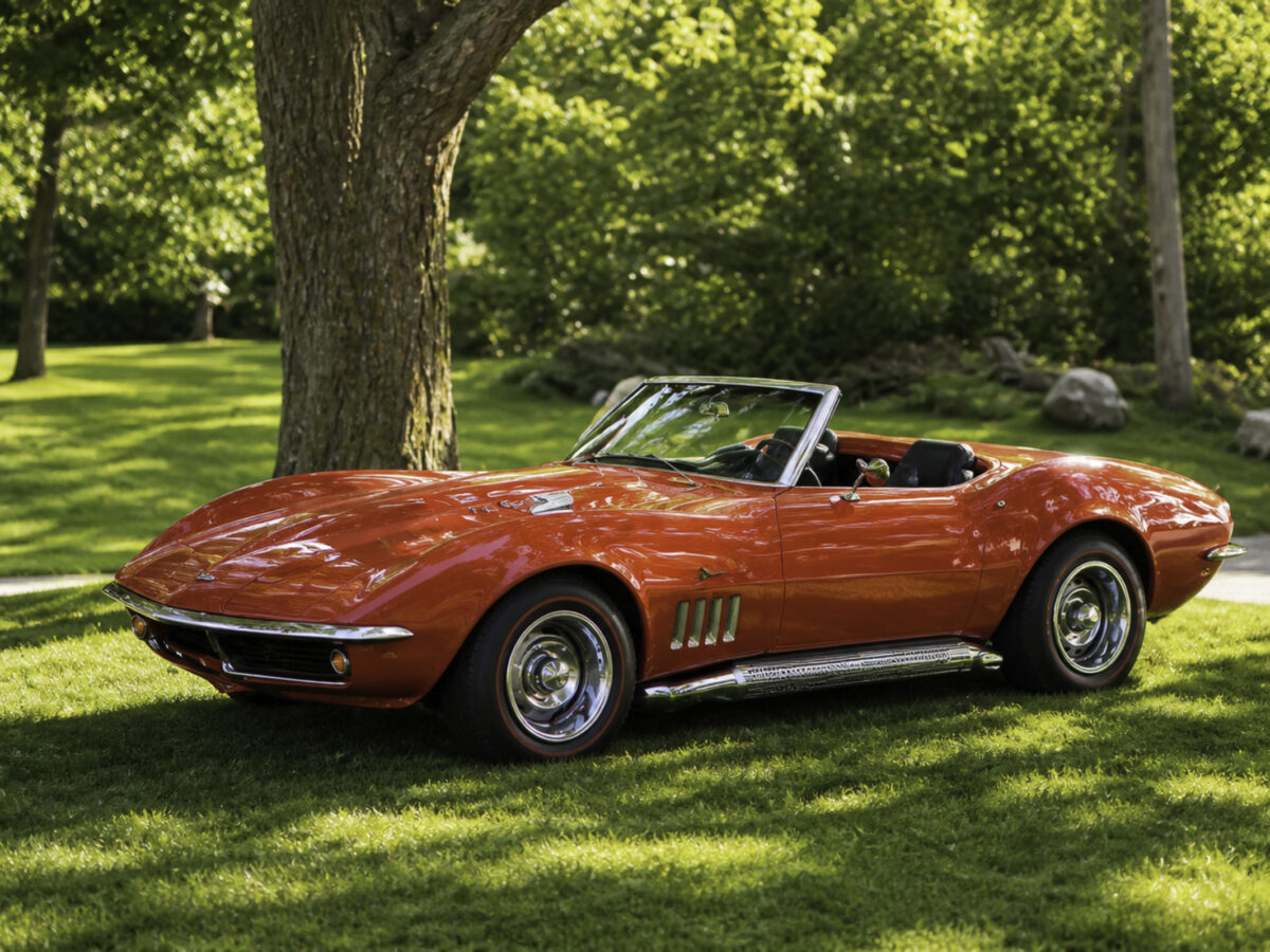 AI-remastered red classic Chevrolet Corvette convertible on a lawn after restoration by Corvette Connection in Bolton, Connecticut.