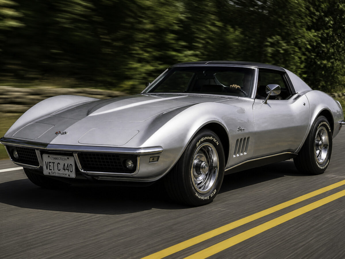 AI-remastered silver classic Chevrolet Corvette driving on the road after restoration by Corvette Connection in Bolton, Connecticut.