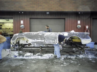 1954 Corvette body in bare fiberglass at Corvette Connection shop showing repair areas