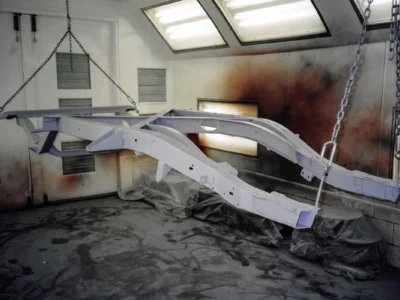 1954 Corvette body panels hanging in paint booth during restoration at Corvette Connection