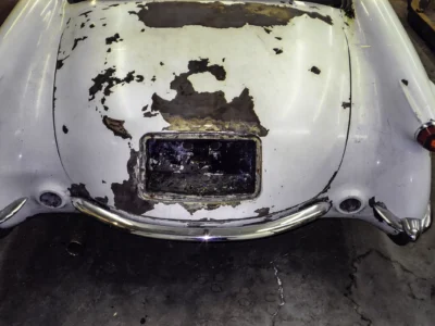 1954 Corvette back section showing fiberglass damage and missing lights before restoration