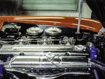 1954 Corvette restored Blue Flame engine bay with chrome air cleaner in red painted car