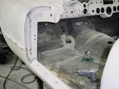 1954 Corvette interior in white primer showing restored body structure