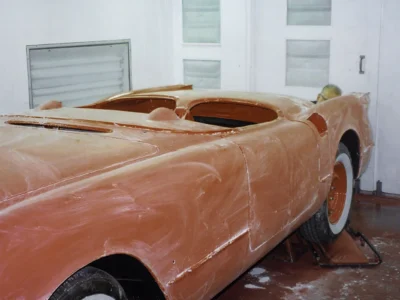1954 Corvette body in fresh red paint in paint booth at Corvette Connection
