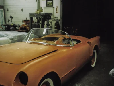 1954 Corvette body in orange primer during paint process at Corvette Connection