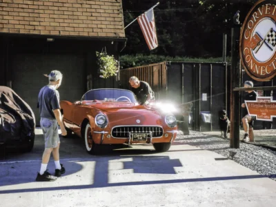 Owner with completed 1954 Corvette in red at Corvette Connection shop
