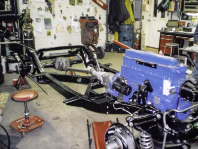 1954 Corvette frame with Blue Flame engine and drivetrain installed in shop at Corvette Connection
