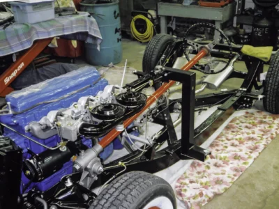 1954 Corvette front suspension and Blue Flame engine close-up during chassis assembly