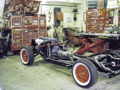 1954 Corvette rolling chassis on jack stands during mechanical assembly at Corvette Connection