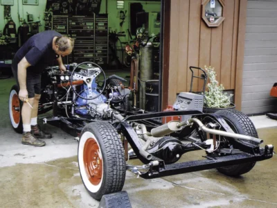 1954 Corvette rolling chassis with Blue Flame engine and red wheels at Corvette Connection in Bolton CT