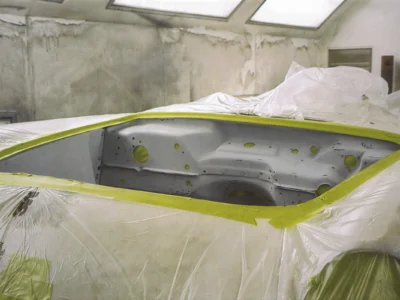 1954 Corvette body panels masked and ready for final paint in paint booth