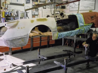 1954 Corvette body on rotisserie showing headlight and fender repair areas