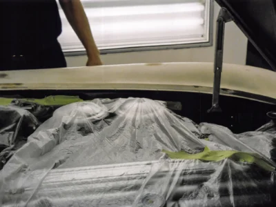 1954 Corvette body covered with plastic sheeting during paint process at Corvette Connection