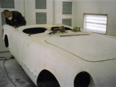 1954 Corvette body in white primer rear view in paint booth at Corvette Connection