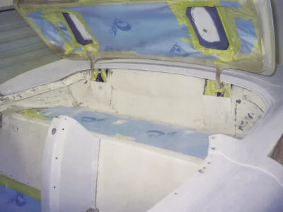 1954 Corvette rear deck and fender in white paint with blue masking tape in paint booth