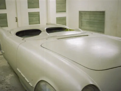 1954 Corvette body in final white paint showing smooth finish in paint booth