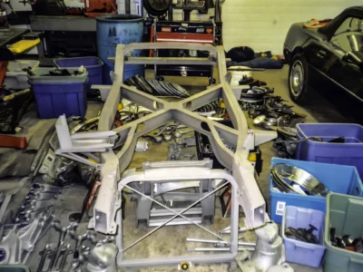 Bare 1957 Corvette frame stripped to crossmembers during frame-off restoration