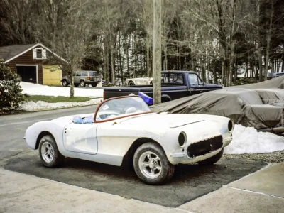 1957 Corvette in primer outdoors front three-quarter view at Corvette Connection in Bolton CT