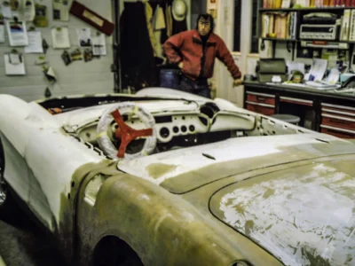Technician working on 1957 Corvette body in primer at Corvette Connection