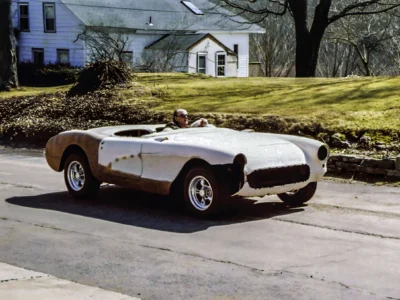 1957 Corvette in primer and red rear three-quarter view outdoors before final paint