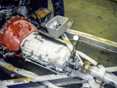 1957 Corvette transmission and drivetrain installed on rolling chassis in shop