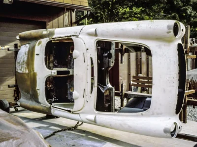 1957 Corvette body interior structure showing door openings and cowl area stripped to bare fiberglass