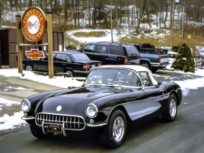 Restored 1957 Corvette in black and white front three-quarter view at Corvette Connection