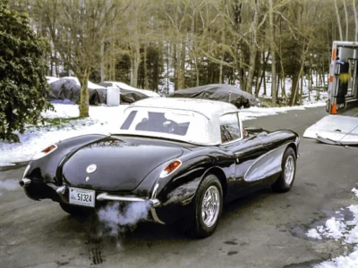 Completed 1957 Corvette in black front three-quarter view outdoors at Corvette Connection in Bolton CT