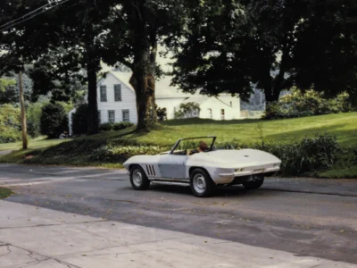 1965 Corvette Sting Ray convertible in primer outdoors side profile at Corvette Connection