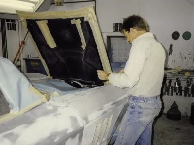 Technician fitting interior panel on 1965 Corvette Sting Ray during restoration at Corvette Connection