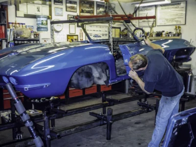 1966 Corvette Sting Ray body on lift during body separation at Corvette Connection