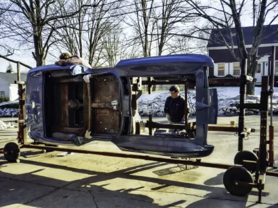 1966 Corvette Sting Ray body on rotisserie outdoors showing interior structure at Corvette Connection