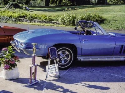 1966 Corvette Sting Ray in Nassau Blue with hood up at car show showing engine bay