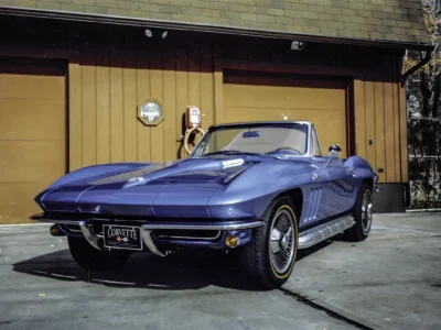 Completed 1966 Corvette Sting Ray convertible in Nassau Blue at Corvette Connection garage door in Bolton CT