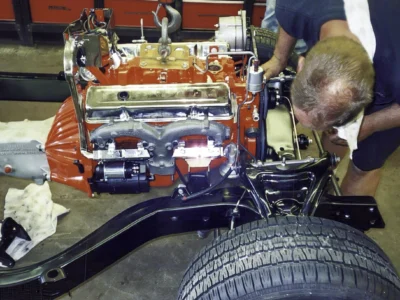 Close-up of red small-block engine and front chassis components on a 1968 Corvette restoration