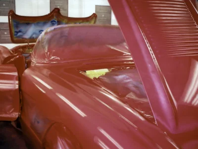 Front fender and hood detail of red 1958 Corvette during paint stage at Corvette Connection