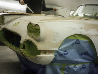 Front fender detail of 1958 Corvette body during cove area paint prep at Corvette Connection