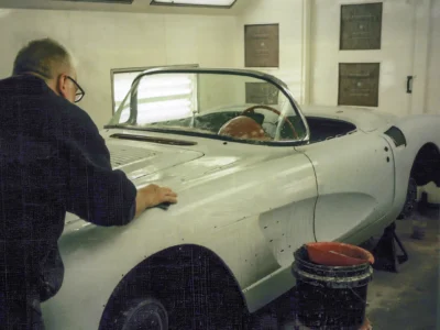 Corvette Connection technician working inside 1958 Corvette body shell during interior prep