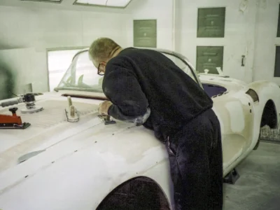 Corvette Connection technician sanding 1958 Corvette rear quarter during paint prep