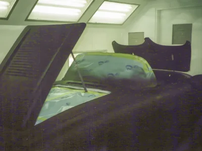 Hood and windshield detail on 1958 Corvette body in primer during bodywork stage