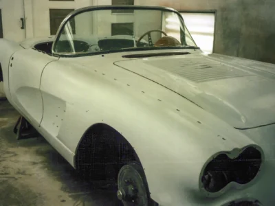 Side profile of 1958 Corvette body in white primer ready for paint at Corvette Connection