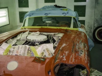 1958 Corvette body with original red paint and white cove during teardown inspection