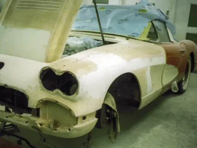 Rear quarter of 1958 Corvette body in primer during bodywork at Corvette Connection