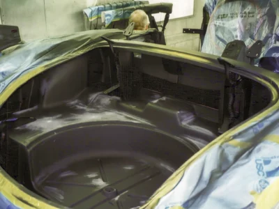Engine bay of 1958 Corvette stripped to bare fiberglass during interior prep work