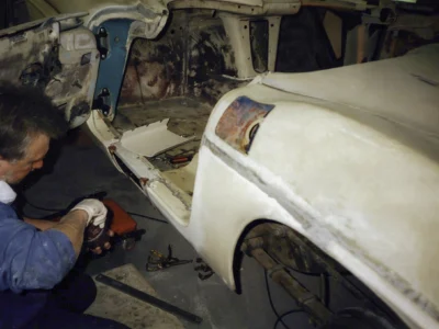 Front three-quarter of 1962 Corvette body shell in primer at Corvette Connection