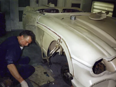 Side profile of 1962 Corvette body shell in primer during bodywork stage