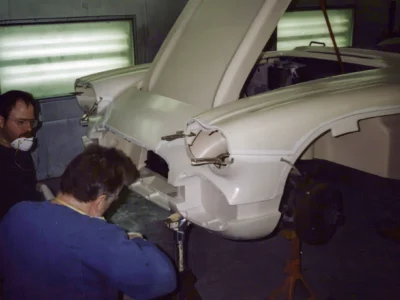 Corvette Connection technician sanding 1962 Corvette front fender during paint prep