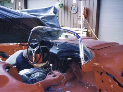 Engine bay detail of red 1962 Corvette during steering column installation