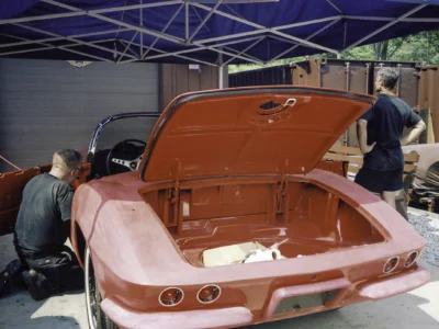 Engine bay and front clip of red 1962 Corvette during final assembly at Corvette Connection