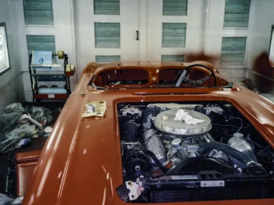 Engine bay detail of red 1962 Corvette during component reinstallation at Corvette Connection